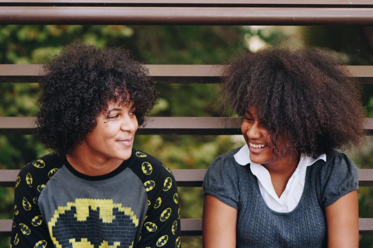 Images shows siblings laughing together