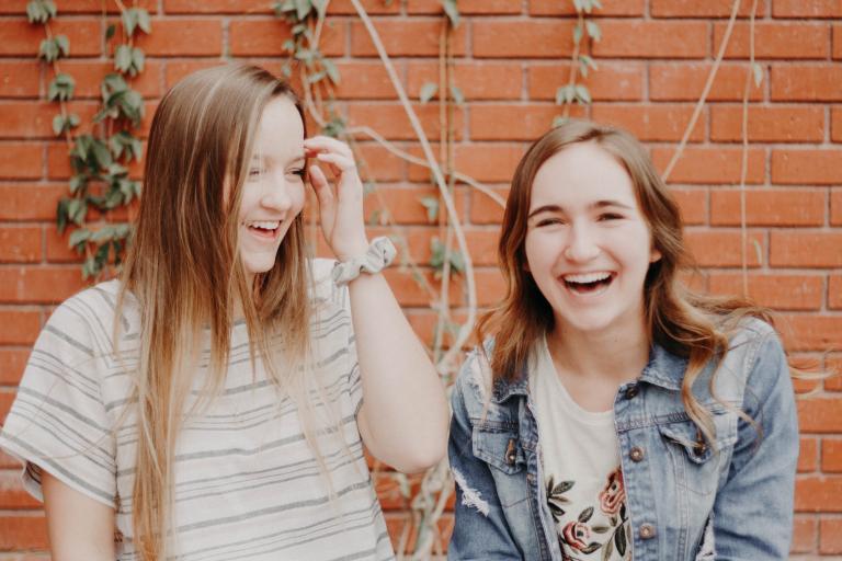 two girls laughing together